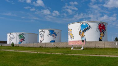 Three Hat's Off tanks on Barlow Trail at the northeast corner of the international airport in Calgary, Alberta, Canada, on July 3, 2023. Hat's Off is a roadside attraction clipart