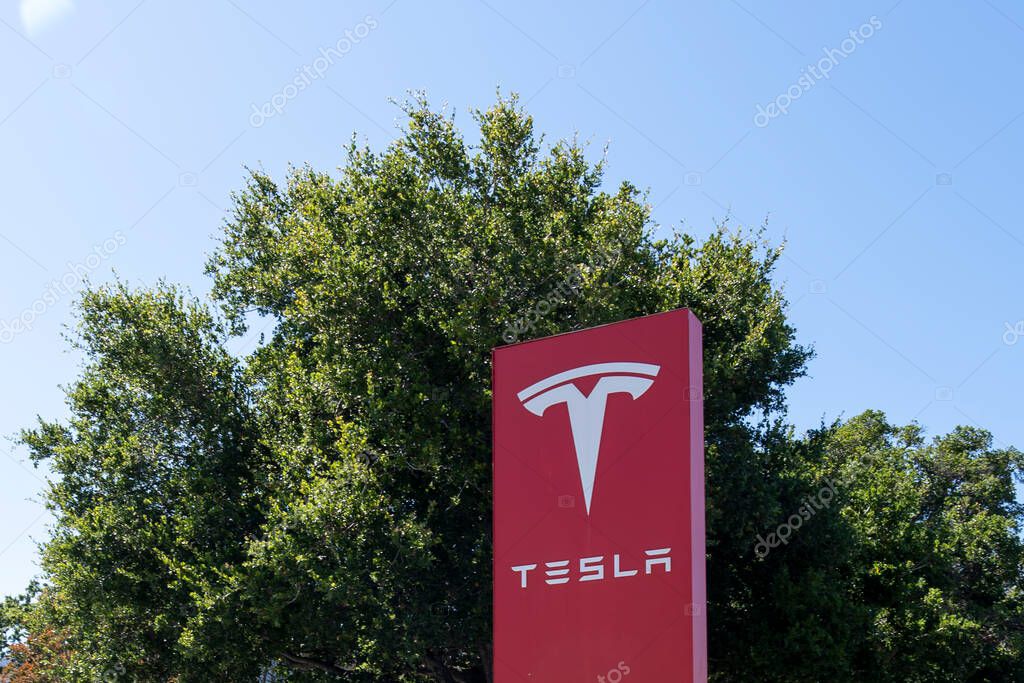 Palo Alto, California, USA - June 18, 2023: Tesla ground sign is seen at the office in Palo Alto, California, USA. Tesla, Inc. is an American multinational automotive and clean energy company.