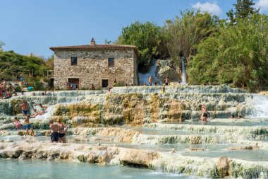 Saturnia, Grosseto, Italy - July 19, 2024: People bathing in the pools at Cascate del Mulino-Hot Spring in Saturnia, Grosseto, Italy. clipart