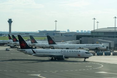 Mississauga, ON, Canada - July 17, 2024: Air Canada planes parked at Torontos Pearson International Airport in Mississauga, ON, Canada. Air Canada is Canada's largest airline. clipart