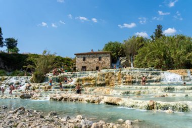 Saturnia, Grosseto, Italy - July 19, 2024: People bathing in the pools at Cascate del Mulino-Hot Spring in Saturnia, Grosseto, Italy.