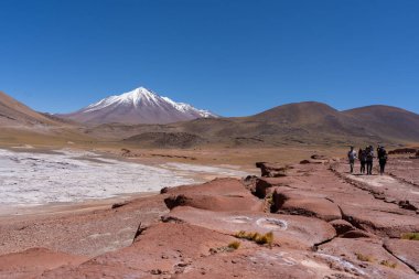 San Pedro de Atacama, Chile - February 23, 2023: Tourists visiting Red Rocks (Piedras Rojas), lagoon and salt flats in Atacama Desert, Chile. clipart