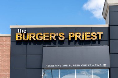 Guelph, Ontario, Canada - June 28, 2020: A The Burger's Priest Restaurant at Stone Road Mall in Guelph, Ontario, Canada.  clipart