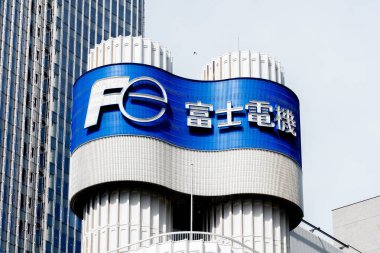 Tokyo, Japan - April 5, 2019: Sign of Fuji Electric Co., Ltd. (FE) on the building in Tokyo, Japan. FE is a Japanese electrical equipment company. clipart