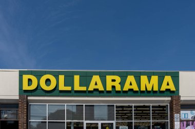 Thornhill, ON, Canada - September 20, 2024: Closeup of Dollarama store logo sign on the building. Thornhill, ON, Canada. Dollarama Inc. is a Canadian dollar store retail chain. clipart