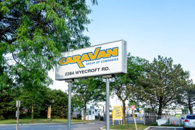 Oakville, Ontario, Canada - July 28, 2019: Sign of Caravan Group of Companies in Oakville, Ontario, Canada, one of Canadas premiere, privately owned, cross border transportation carriers. clipart