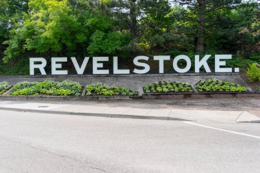 Revelstoke ground sign in British Columbia, Canada - July 6, 2023. Revelstoke is a city in southeastern British Columbia, Canada. clipart