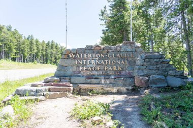 Waterton Glacier International Peace Park Sign along side of road clipart