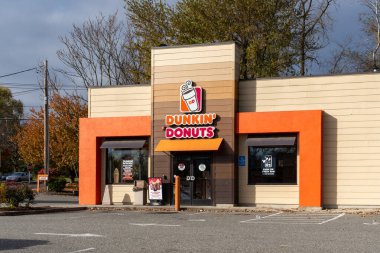 A Dunkin' Donuts restaurant in West Springfield, MA, USA, on November 12, 2023. Dunkin' is an American multinational coffee and doughnut company. clipart