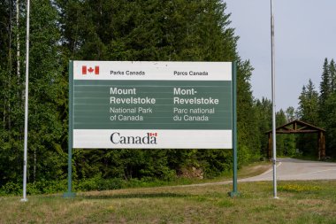 The entrance sign of Mount Revelstoke National Park, BC, Canada - July 6, 2023. Mount Revelstoke National Park is a national park located adjacent to the city of Revelstoke, BC, Canada. clipart