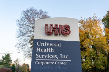 Universal Health Services (UHS) logo sign outside of its headquarters in King of Prussia, PA, USA, November 5, 2023. UHS is an American company that provides hospital and healthcare services. clipart