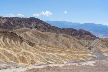 View of Zabriskie Point in Death Valley National Park in California, United States. Zabriskie Point is a part of the Amargosa Range located east of Death Valley noted for its erosional landscape. clipart