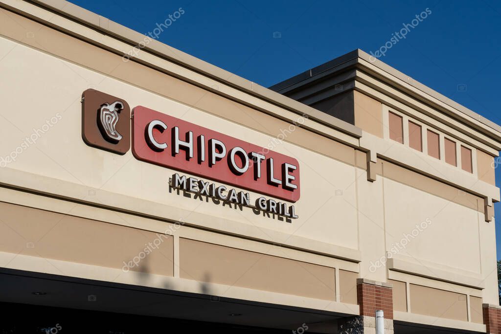 Houston, Texas, USA - April 12, 2024: Close up of Chipotle Mexican Grill restaurant sign on building. Chipotle is an American chain of fast casual restaurants.