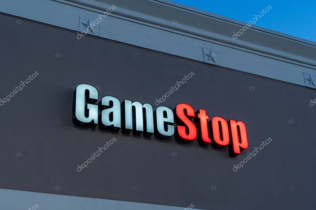 Pearland, TX, USA - April 12, 2024: Close up of GameStop store sign at night is shown. GameStop Corp. is an American video game, consumer electronics, and gaming merchandise retailer.
