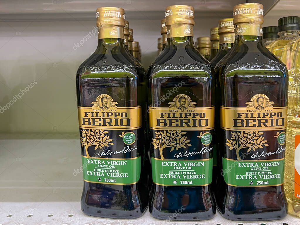 Calgary, Alberta, Canada - July 18, 2023: Oils, Filippo Berio Extra Virgin Olive Oil 750 ml bottles for sale on the shelves in a supermarket. Calgary, Alberta, Canada.
