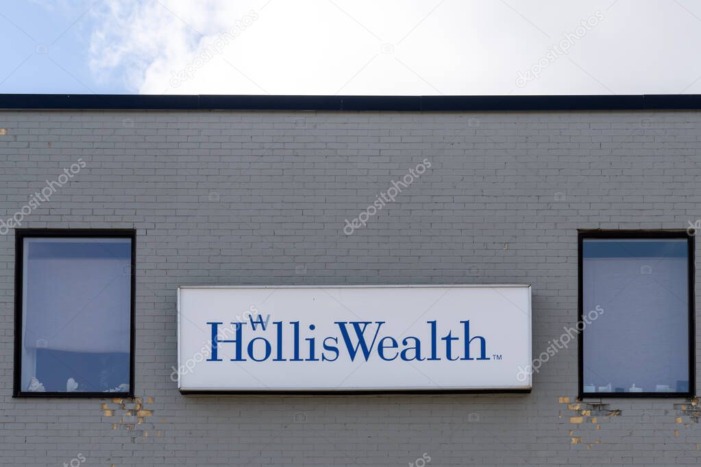 Kitchener, Ontario, Canada - October 17, 2020: HollisWealth company sign on the wall in Kitchener, Ontario, Canada. HollisWealth is Canada's premier financial advisory networks.