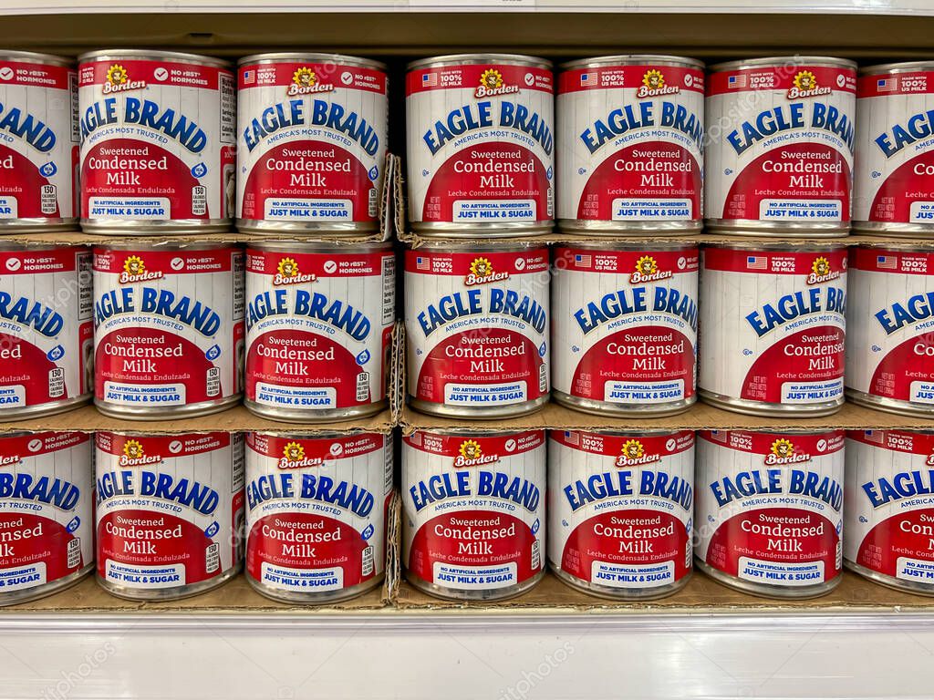 Utah, USA - June 26, 2023: Borden Eagle Brand Sweetened Condensed Milk cans on the shelves in a supermarket. Utah, USA.