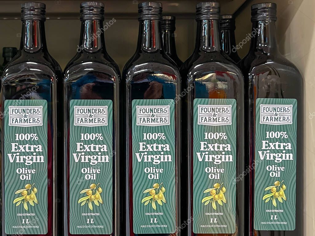 Alberta, Canada - July 3, 2023: Founders Farmers 100% Extra Virgin Olive Oil 1L bottles on the shelves in a supermarket. Alberta, Canada.