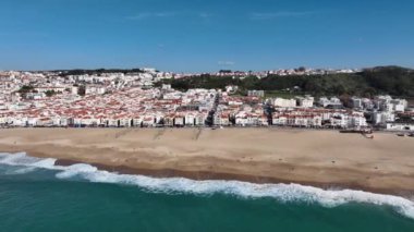 Portekiz 'deki Nazare Kasabası. Plaj ve şehir manzarası. İnsansız hava aracı bakış açısı. 4k