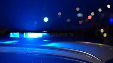 Blue light flasher on top of a police car.