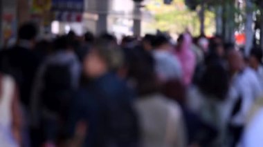 Blurry Japanese People in Tokyo. Business District. Rush Hour Time People Are Walking on the Sidewalk. Japan