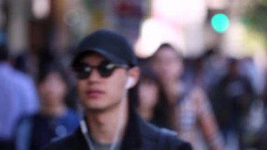 Blurry Japanese People in Tokyo. Business District. Rush Hour Time People Are Walking on the Sidewalk. Japan