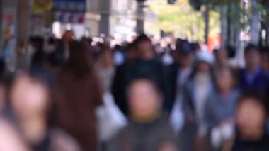 Blurry Japanese People in Tokyo. Business District. Rush Hour Time People Are Walking on the Sidewalk. Japan