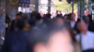 Blurry Japanese People in Tokyo. Business District. Rush Hour Time People Are Walking on the Sidewalk. Japan