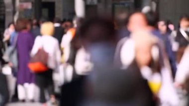 Blurry People in Tokyo City. Business District. Rush Hour Time People Are Walking on the Sidewalk. Japanese People