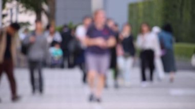 Blurry People Walking on the Sidewalk. Business District. Rush Hour Time. Asian City and Asian People. Blurry Background.