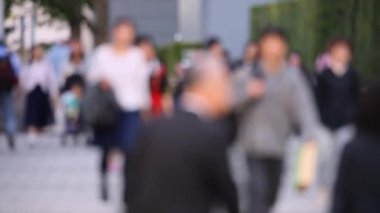 Blurry People Walking on the Sidewalk. Business District. Rush Hour Time. Asian City and Asian People. Blurry Background.