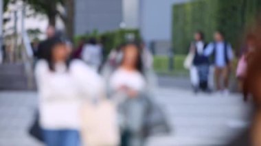 Blurry People Walking on the Sidewalk. Business District. Rush Hour Time. Asian City and Asian People. Blurry Background.