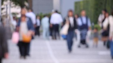 Blurry People Walking on the Sidewalk. Business District. Rush Hour Time. Asian City and Asian People. Blurry Background.