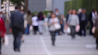 Blurry People Walking on the Sidewalk. Business District. Rush Hour Time. Asian City and Asian People. Blurry Background.