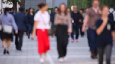 Blurry People Walking on the Sidewalk. Business District. Rush Hour Time. Asian City and Asian People. Blurry Background.