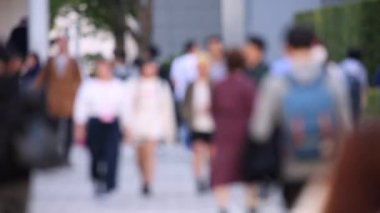 Blurry People Walking on the Sidewalk. Business District. Rush Hour Time. Asian City and Asian People. Blurry Background.