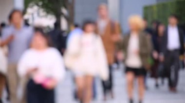 Blurry People Walking on the Sidewalk. Business District. Rush Hour Time. Asian City and Asian People. Blurry Background.