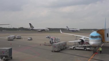 Korean Airlines airplane Airbus a220 arrived to Tokyo International Narita Airport. Ground Service is Working in Background. Singapore and Nippon Cargo Airlines Airplanes Are Taxing to Take Off