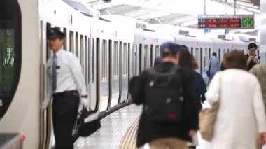 Metro Train Station Platform in Tokyo. People are Rushing on Platform in Underground Metro Train Station During Rush Hour. Train is Ready To Depart.