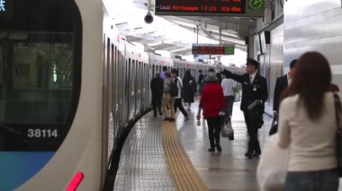 Metro Train Station Platform in Tokyo. Underground Metro Train During Rush Hour is Ready to Depart. People are Running to the Train. Asian commuters traveling.