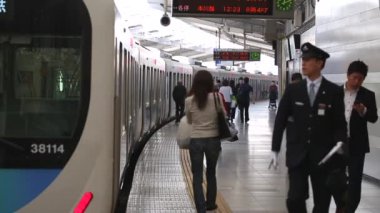 Metro Train Station Platform in Tokyo. Underground Metro Train During Rush Hour is Ready to Depart. People are Running to the Train. Asian commuters traveling.