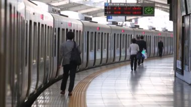 Metro Train Station Platform in Tokyo. Underground Metro Train During Rush Hour is Ready to Depart. People are Running to the Train. Asian commuters traveling.