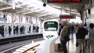 Metro Train Station Platform in Tokyo. Underground Metro Train During Rush is Approaching. People Are Waiting. Asian commuters traveling. Train Approaching.