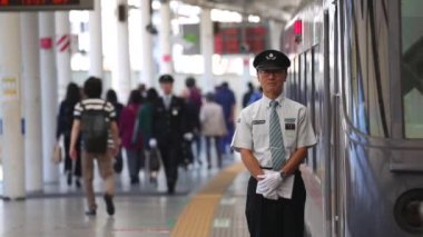 Metro Train Station Platform in Tokyo. Underground Metro Train Station During Rush Hour. Conductor is Waiting By The Train