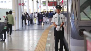 Metro Train Station Platform in Tokyo. Underground Metro Train Station During Rush Hour. Conductor is Waiting By The Train