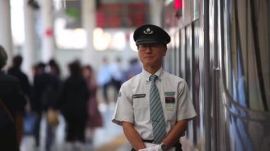 Metro Train Station Platform in Tokyo. Underground Metro Train Station During Rush Hour. Conductor is Waiting By The Train