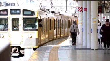 Metro Train Station Platform in Tokyo. Underground Metro Train Station During Rush Hour. Seibu Haijima Line Train is Departing. Asian commuters traveling.