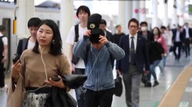 Metro Train Station Platform in Tokyo. Underground Metro Train Station During Rush Hour. Seibu Train Station. People Leaving Station and Walking on Platform. Asian commuters traveling.