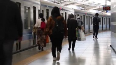 Metro Trains Station Platform in Tokyo. Underground Metro Train During Rush is Ready to Depart. People are Running to the Train. Asian commuters traveling