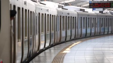 Metro Train Station Platform in Tokyo. Underground Metro Train Station During Rush Hour. The Train is Departing. Asian commuters traveling.